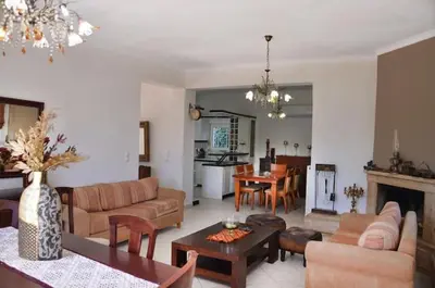 a living room with a couch and a table at Villa Esperado Gardens Maleme in Maleme