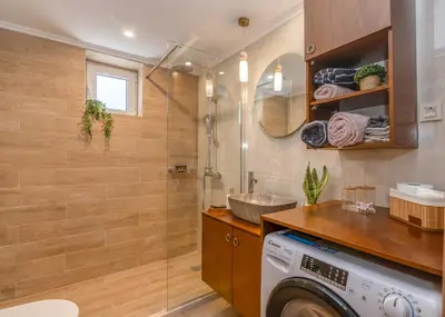 a bathroom with a washing machine and a sink at Anamniseis Giorgio Falasarna in Plátanos