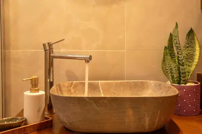 a bathroom with a sink with a faucet at Anamniseis Giorgio Falasarna in Plátanos