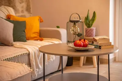 a living room with a table with fruit on it at Anamniseis Giorgio Falasarna in Plátanos
