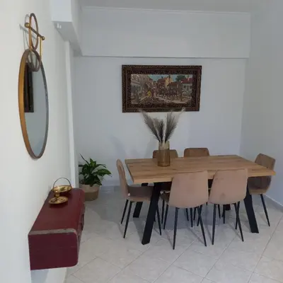 a dining room with a wooden table and chairs at Kornaros House in Chania Town