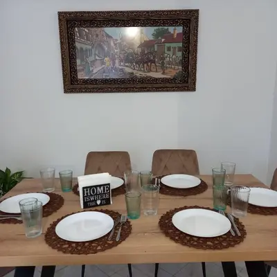 a table with plates and glasses and a sign on it at Kornaros House in Chania Town