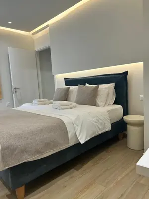 a bedroom with a large bed with white pillows at Chania Moments in Chania Town