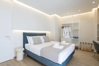 a bedroom with a bed with two towels on it at Chania Moments in Chania Town