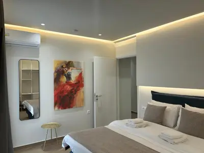 a bedroom with a bed and a painting on the wall at Chania Moments in Chania Town