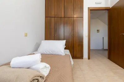 a bedroom with a bed with two pillows on it at Sense of Dream Villas in Tavronitis