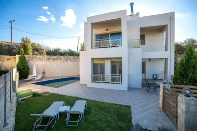 a villa with a swimming pool and a house at Sense of Dream Villas in Tavronitis