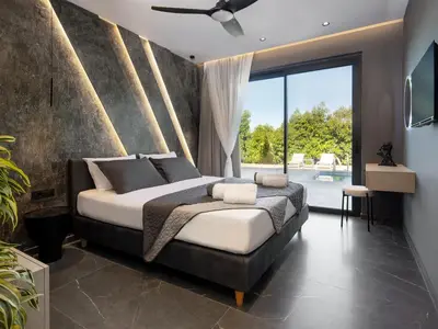 a bedroom with a large bed and a large window at PanStel Twin Villas with private pools and jacuzzi in Ayiá