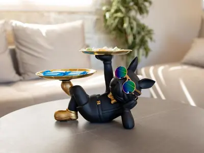 a figurine of a dog holding a tray on a table at PanStel Twin Villas with private pools and jacuzzi in Ayiá