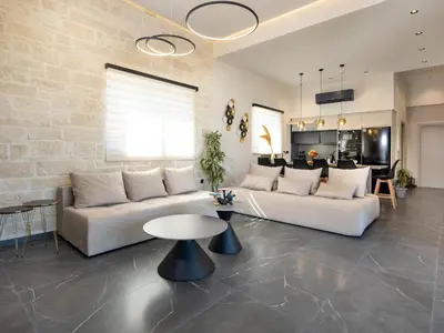 a living room with a white couch and a table at PanStel Twin Villas with private pools and jacuzzi in Ayiá