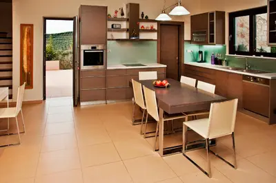 a kitchen and dining room with a table and chairs at Villa Lofos in Perivólia