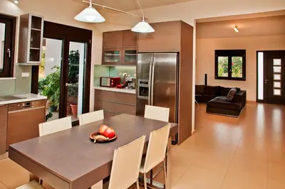 a kitchen and dining room with a table and chairs at Villa Lofos in Perivólia