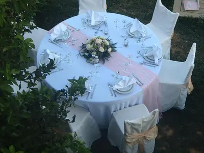 a white table with a flower arrangement on it at Villa Lofos in Perivólia