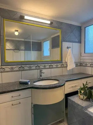 a bathroom with a sink and a large mirror at Nature spacious apt, 2km from Chania old town, private parking in Chania Town