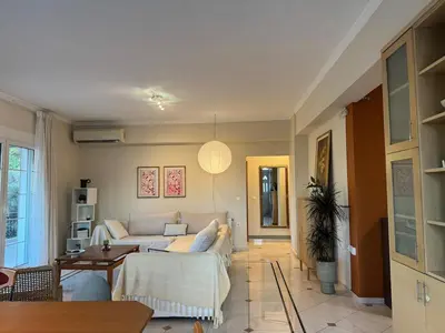 a living room with a couch and a table at Nature spacious apt, 2km from Chania old town, private parking in Chania Town