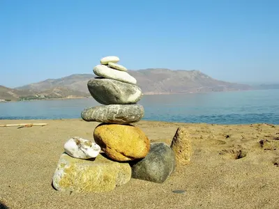 a stack of rocks sitting on a beach at Callista sea view or garden in Kissamos