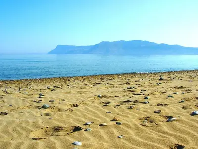 a beach with rocks in the sand and the ocean at Callista sea view or garden in Kissamos