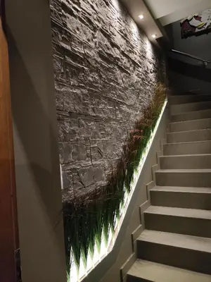 a staircase with a stone wall and some grass at Mirma City apartment2 Old Town in Chania Town
