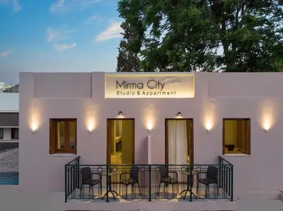 a white building with a sign that reads mimino city sticks a presentation at Mirma City apartment2 Old Town in Chania Town