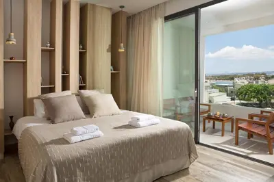 a bedroom with a large bed with towels on it at S&K Villas in Kalamaki Chanion