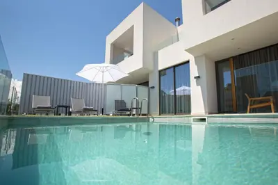 a swimming pool in front of a building at S&K Villas in Kalamaki Chanion