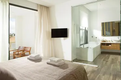 a bedroom with a bed with towels on it at S&K Villas in Kalamaki Chanion