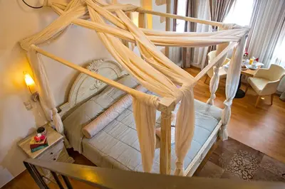 a bed with a canopy in a living room at Ionas Boutique Hotel in Chania Town