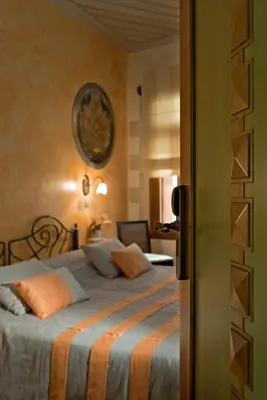 a bedroom with a large bed with orange pillows at Ionas Boutique Hotel in Chania Town