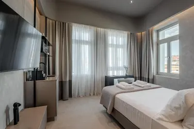 a hotel room with a bed and a television at Amara Luxury Suites With Private Hot Tub in Chania Town
