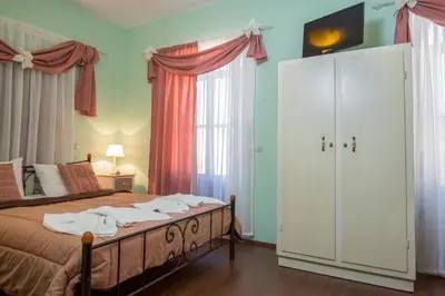 a bedroom with a bed and a large window at Casa Di Porto in Chania Town
