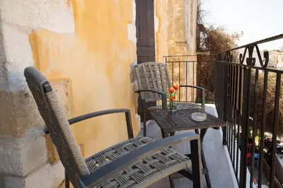 two chairs and a table on a balcony at Casa Di Porto in Chania Town