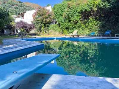 a pool of water with a reflection of trees in it at Elafonisi Manor with Private Pool & Jaccuzi in Perivólia