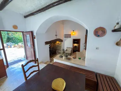 a dining room with a table and a fireplace at Elafonisi Manor with Private Pool & Jaccuzi in Perivólia