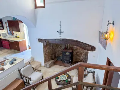 a view of a living room with a stone fireplace at Elafonisi Manor with Private Pool & Jaccuzi in Perivólia