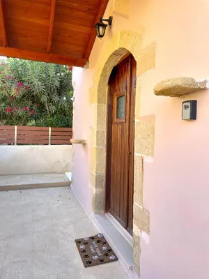 a door to a house with a porch at Wild Tulip Escape in Kolymvari