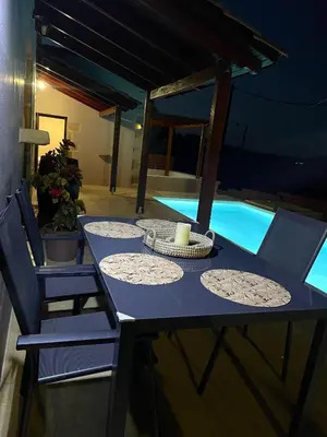 a blue table with chairs and a candle on top at Wild Tulip Escape in Kolymvari
