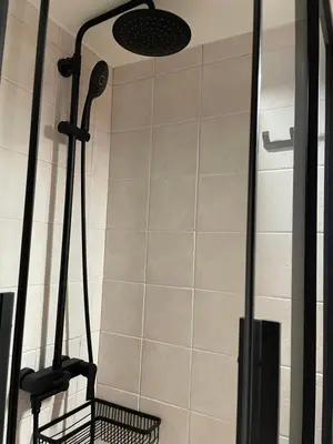 a bathroom with a shower with a black shower head at Wild Tulip Escape in Kolymvari