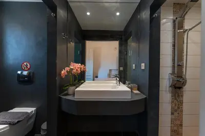 a bathroom with a white sink and a shower at Villa Enid in Sinoikismós Mamounianá