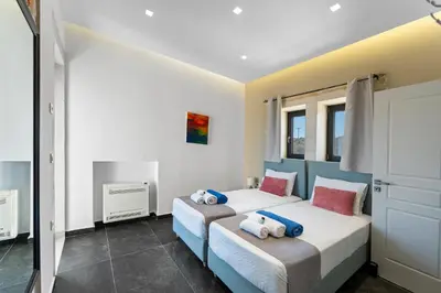 a bedroom with two beds with towels on them at Villa Enid in Sinoikismós Mamounianá