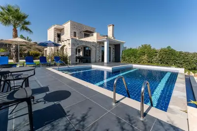 a villa with a swimming pool and a house at Villa Enid in Sinoikismós Mamounianá