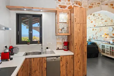 a kitchen with a sink and a window at Villa Resi in Vamos