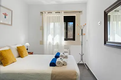 a bedroom with a bed with towels on it at Villa Resi in Vamos