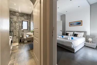 a bedroom with a king sized bed and a bathroom at Villa Resi in Vamos