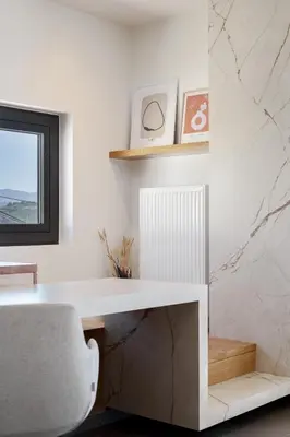 a white desk and a chair in a room at Alectrona Living Crete, Villa Mezcal in Plataniás