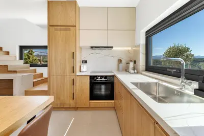 a kitchen with a sink and a window at Alectrona Living Crete, Villa Mezcal in Plataniás