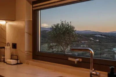 a bathroom window with a view of a tree at Alectrona Living Crete, Villa Mezcal in Plataniás
