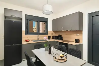 a kitchen with a table and chairs in a kitchen at LUV Group of 4 Villas in Kathiana in Kathiana