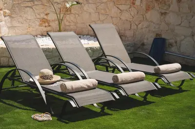 a group of lawn chairs sitting on the grass at LUV Group of 4 Villas in Kathiana in Kathiana