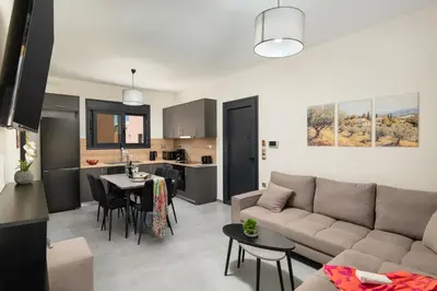 a living room and kitchen with a couch and a table at LUV Group of 4 Villas in Kathiana in Kathiana
