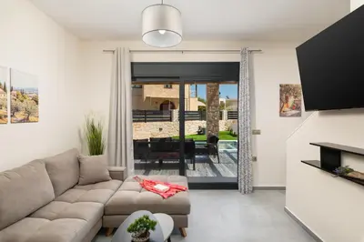 a living room with a couch and a television at LUV Group of 4 Villas in Kathiana in Kathiana